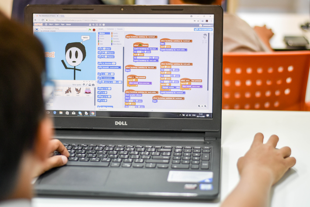 A photo of a young child using Scratch to learn coding skills.