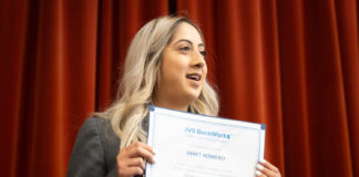 JVS BankWork$ graduate Janet Romero shows off her certificate of completion at her graduation ceremony in April.