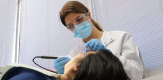Helen Akopyan works on patient's teeth.