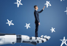 A businessman stands on a giant robotic arm and reaches to chalk-drawn stars.