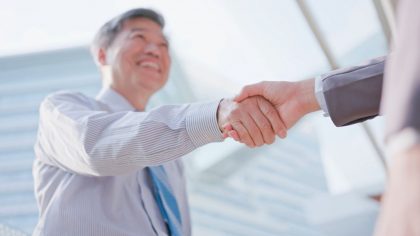 older asian man handshake